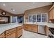 Bright kitchen features stainless steel appliances, wood cabinetry, and a view of the lake at 12754 E Laurel Ln, Scottsdale, AZ 85259
