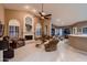 Inviting living room with a fireplace, arched windows, and comfortable seating at 12754 E Laurel Ln, Scottsdale, AZ 85259