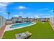 Spacious backyard featuring a pool, pergola, artificial turf, and entertaining spaces at 12826 N 29Th St, Phoenix, AZ 85032