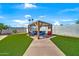 Expansive backyard oasis with lush artificial turf, a pergola, and comfortable lounge seating at 12826 N 29Th St, Phoenix, AZ 85032
