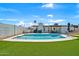 Well-maintained backyard with a pool, lush artificial turf, and privacy fencing at 12826 N 29Th St, Phoenix, AZ 85032