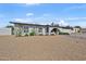 Single-story home showcasing desert landscaping, a blue walkway, and arched entrance at 12826 N 29Th St, Phoenix, AZ 85032