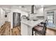 Bright kitchen featuring a kitchen island with seating, stainless steel appliances and white cabinets at 12826 N 29Th St, Phoenix, AZ 85032