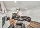 Bright living room featuring a leather sectional, modern decor, and wood flooring at 12826 N 29Th St, Phoenix, AZ 85032