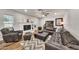 Bright living room with a leather sectional, white brick fireplace, and modern decor at 12826 N 29Th St, Phoenix, AZ 85032