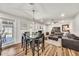 Open-concept living and dining area featuring modern decor and wood flooring at 12826 N 29Th St, Phoenix, AZ 85032