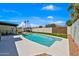 Inviting backyard with a pool, pergola, artificial turf, and outdoor seating at 12826 N 29Th St, Phoenix, AZ 85032