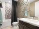 Well-lit bathroom featuring a stylish vanity, decorative wall accents, and modern fixtures at 13406 W Rowel Rd, Peoria, AZ 85383