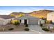 Charming single-story home with a gray roof, desert landscaping, and a two-car garage at 13406 W Rowel Rd, Peoria, AZ 85383