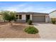 Charming single-story home with a low-maintenance front yard and a paved driveway leading to a two-car garage at 13406 W Rowel Rd, Peoria, AZ 85383