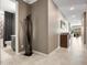 Inviting hallway featuring neutral tones, leading to a bright living area with desert views at 13406 W Rowel Rd, Peoria, AZ 85383