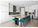 Beautiful kitchen boasting white cabinets, stainless steel appliances, and a large island with seating at 13406 W Rowel Rd, Peoria, AZ 85383