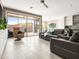 Bright living room with tile floors, comfortable seating, and sliding glass doors leading to the outdoor patio at 13406 W Rowel Rd, Peoria, AZ 85383