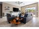 Comfortable living room featuring modern furniture, a large flat-screen TV, and a sliding glass door at 13406 W Rowel Rd, Peoria, AZ 85383