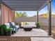 Outdoor seating area with pergola, comfortable couches, and a modern fire pit at 13406 W Rowel Rd, Peoria, AZ 85383