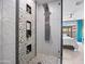 Modern shower with stone accents, rainfall showerhead, and sleek design at 13406 W Rowel Rd, Peoria, AZ 85383