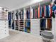 Walk-in closet with custom shelving and clothing racks, creating an organized and stylish storage space at 13406 W Rowel Rd, Peoria, AZ 85383