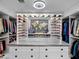 Spacious walk-in closet with custom shelving and drawers for ample storage at 13406 W Rowel Rd, Peoria, AZ 85383