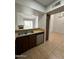 The kitchen has wood cabinets and tile flooring overlooking an open living area at 14002 N 49Th Ave # 1120, Glendale, AZ 85306