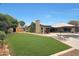 A backyard with a shed, lush green lawn, and covered patio at 14014 N 57Th Way, Scottsdale, AZ 85254