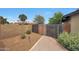 Private backyard featuring a brick walkway, rock landscaping and a decorative fence at 14014 N 57Th Way, Scottsdale, AZ 85254
