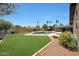 A spacious backyard with a pool, lush green lawn, and a well-maintained landscape at 14014 N 57Th Way, Scottsdale, AZ 85254