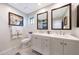Clean bathroom with double sinks, white cabinetry, and modern fixtures and finishes at 14014 N 57Th Way, Scottsdale, AZ 85254