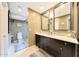 Bathroom with double sinks, granite countertops, and a glass-enclosed shower with neutral tones at 14014 N 57Th Way, Scottsdale, AZ 85254