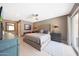 Main bedroom featuring a tufted headboard, access to a balcony, and soft carpet at 14014 N 57Th Way, Scottsdale, AZ 85254