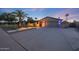 Captivating home exterior featuring desert landscaping, landscape lighting, and an attached garage at 14014 N 57Th Way, Scottsdale, AZ 85254