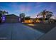 Inviting exterior showcasing a well-manicured yard, charming landscape lighting and attached garage at 14014 N 57Th Way, Scottsdale, AZ 85254