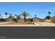 Charming single-story home featuring a neutral color palette, desert landscaping, and a spacious driveway at 14014 N 57Th Way, Scottsdale, AZ 85254