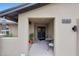 Inviting front porch with seating area and views of a lush garden, leading to an elegant double-door entrance at 14014 N 57Th Way, Scottsdale, AZ 85254