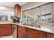 A kitchen sink beneath a window with stainless steel appliances and tile backsplash at 14014 N 57Th Way, Scottsdale, AZ 85254