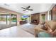 Living room with tile flooring, a fireplace, and a view of the outdoor pool at 14014 N 57Th Way, Scottsdale, AZ 85254
