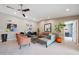 Bright living room featuring tile floors, a sectional sofa, and stylish decor at 14014 N 57Th Way, Scottsdale, AZ 85254