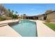 The backyard features a sparkling pool, spa, and ample green space for outdoor activities and relaxation at 14014 N 57Th Way, Scottsdale, AZ 85254