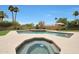The backyard features a refreshing pool and spa with a brick accent wall for added elegance at 14014 N 57Th Way, Scottsdale, AZ 85254
