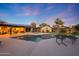 Stunning twilight view of the pool and backyard, illuminated for evening enjoyment and relaxation at 14014 N 57Th Way, Scottsdale, AZ 85254