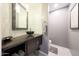 Stylish powder room with vessel sink, decorative mirror, and modern wall covering at 14014 N 57Th Way, Scottsdale, AZ 85254