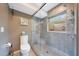 Shower with glass enclosure, gray tile, and a window offering natural light and backyard views at 14014 N 57Th Way, Scottsdale, AZ 85254