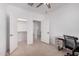 Office space with desk, closet, open doorways, ceiling fan, and tiled floor at 14253 W El Cortez Pl, Surprise, AZ 85387