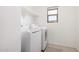 Bright laundry room with washer, dryer, and built-in shelf at 14253 W El Cortez Pl, Surprise, AZ 85387