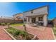 Charming backyard featuring a covered patio, garden bed, and low maintenance landscaping at 14253 W El Cortez Pl, Surprise, AZ 85387