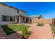 Well-maintained backyard features a covered patio, gravel landscaping, and artificial turf at 14253 W El Cortez Pl, Surprise, AZ 85387