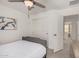 This cozy bedroom features a ceiling fan, natural light, neutral walls, and coordinated decor at 14253 W El Cortez Pl, Surprise, AZ 85387