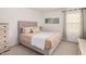 This neutral bedroom features soft bedding, natural light, and coordinated decor at 14253 W El Cortez Pl, Surprise, AZ 85387