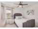 This bedroom features a ceiling fan, natural light, neutral walls, and coordinated decor at 14253 W El Cortez Pl, Surprise, AZ 85387