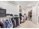 A well-organized walk-in closet provides plenty of storage with rods, shelves and a safe at 14253 W El Cortez Pl, Surprise, AZ 85387
