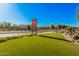 Attractive community signage at the entrance with lush green landscaping and a clear view at 14253 W El Cortez Pl, Surprise, AZ 85387